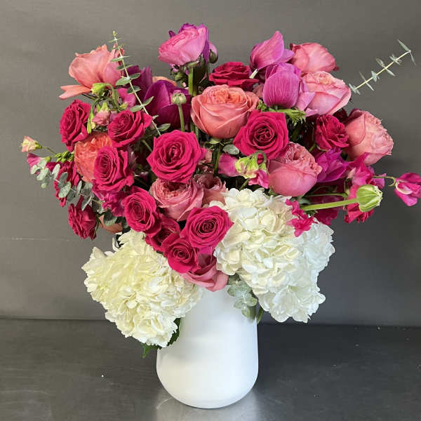 Pink and white floral arrangement in a white vase