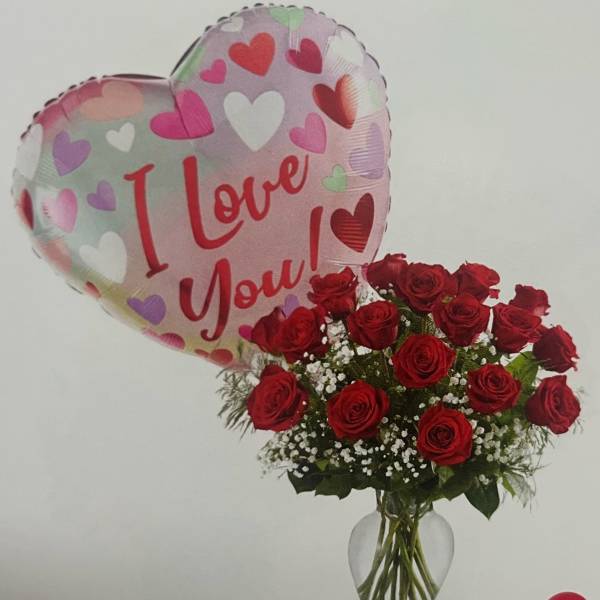 Red roses in a glass vase with a heart-shaped "I Love You" balloon