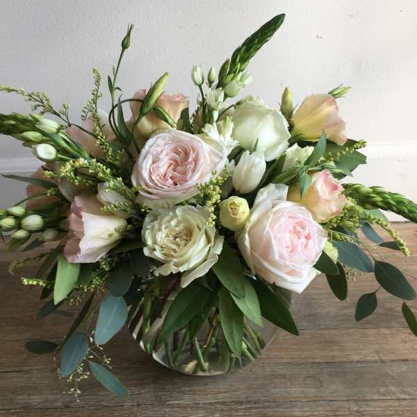 Blush and white rose bouquet in a clear glass vase