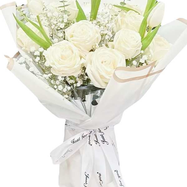 White roses and tulips in a wrapped bouquet