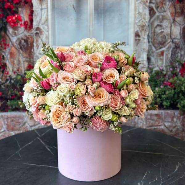 Large pastel bouquet of roses and tulips in a pink box