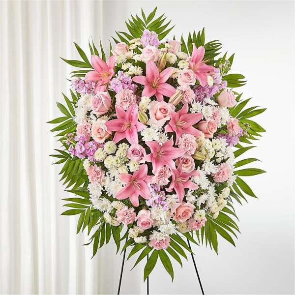 Large pink and white floral standing spray on an easel