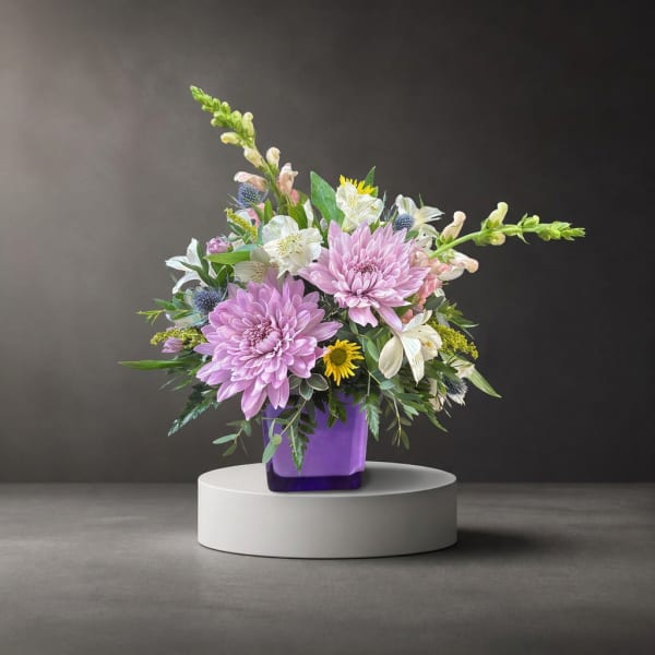 Lavender and white mixed bouquet in a purple vase