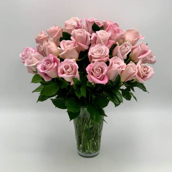 Pink roses arranged in a clear glass vase
