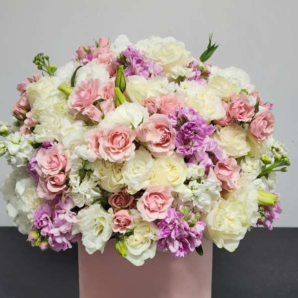 Pink, white, and lavender bouquet in a blush cylindrical box