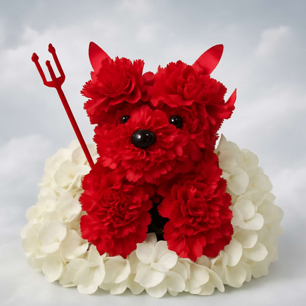 Red teddy bear made of flowers sitting on white petals with a small trident