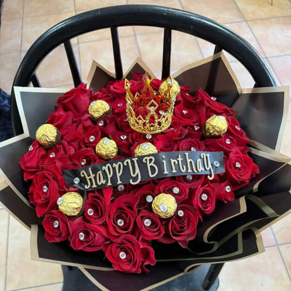 Red rose bouquet with a gold crown and Happy Birthday sign