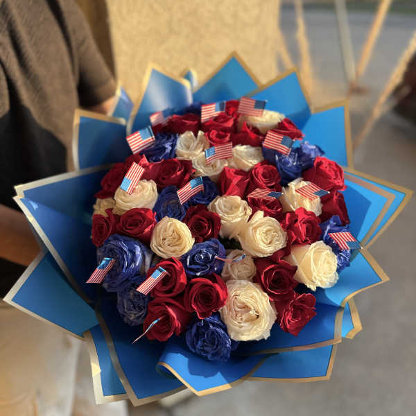 Bouquet of red, white, and blue roses with small American flags