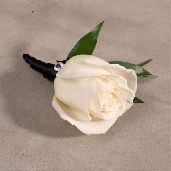 White rose boutonniere with black ribbon wrap and green leaves