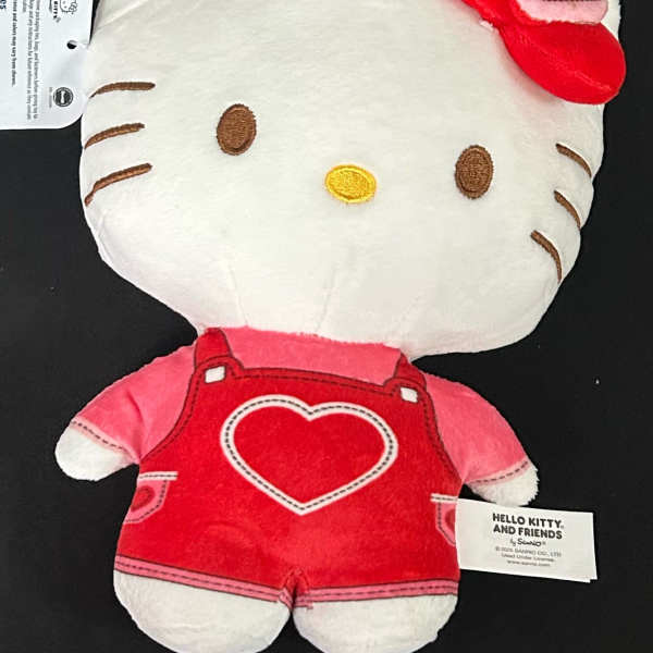 Hello Kitty plush toy in red overalls with a heart detail