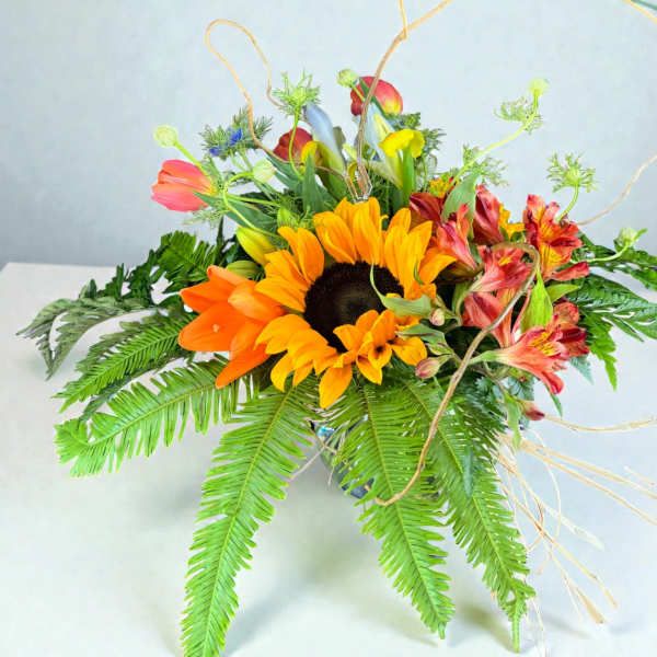 Bright mixed bouquet with sunflowers and orange blooms