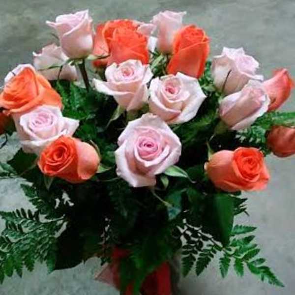 Bouquet of pink and coral roses with fern greenery