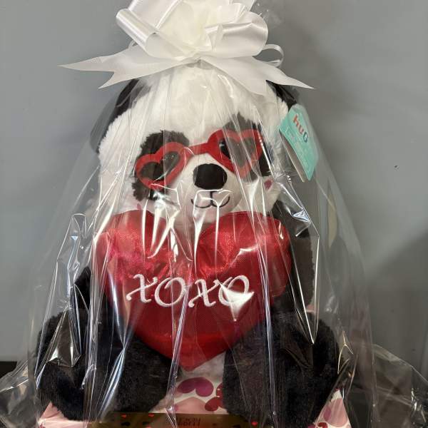 Gift basket with a teddy bear, heart pillow, and Ferrero Rocher chocolates
