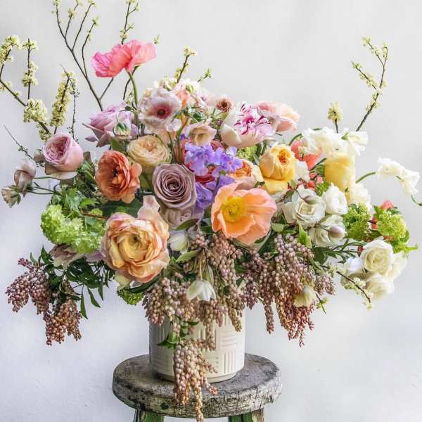 Pastel mixed flower arrangement in a white vase
