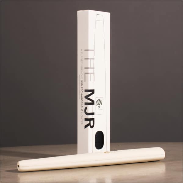 White rechargeable lighter in a box with the lighter laid in front