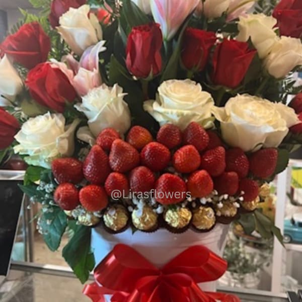 Bouquet of red and white roses with strawberries in a white box