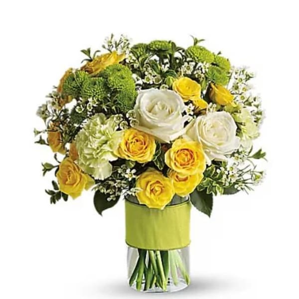 Bouquet of yellow and white roses in a clear glass vase