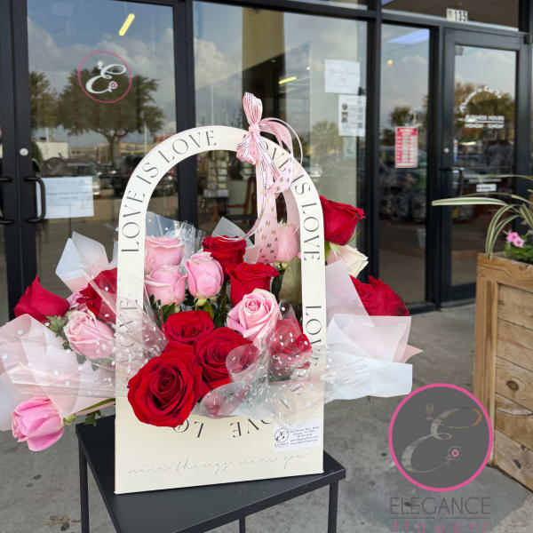 Box arrangement of red and pink roses with a LOVE handle