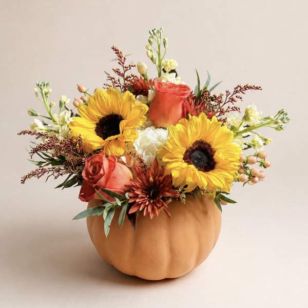 Sunflower and rose arrangement in a pumpkin-shaped container