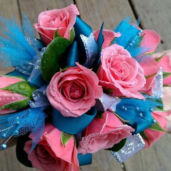 Pink rose wrist corsage with blue ribbon and tulle accents