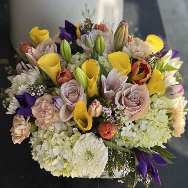 Mixed bouquet with yellow calla lilies, pale roses, and hydrangeas