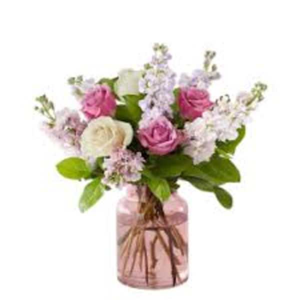 Pink and white roses in a pink glass vase