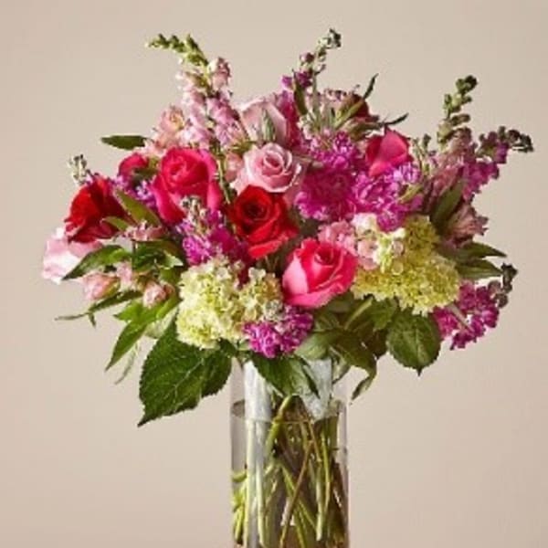Bouquet of pink and red roses in a clear glass vase