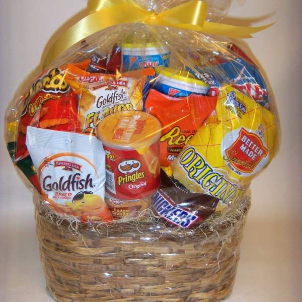 Basket of assorted snack foods wrapped in clear cellophane with a yellow bow