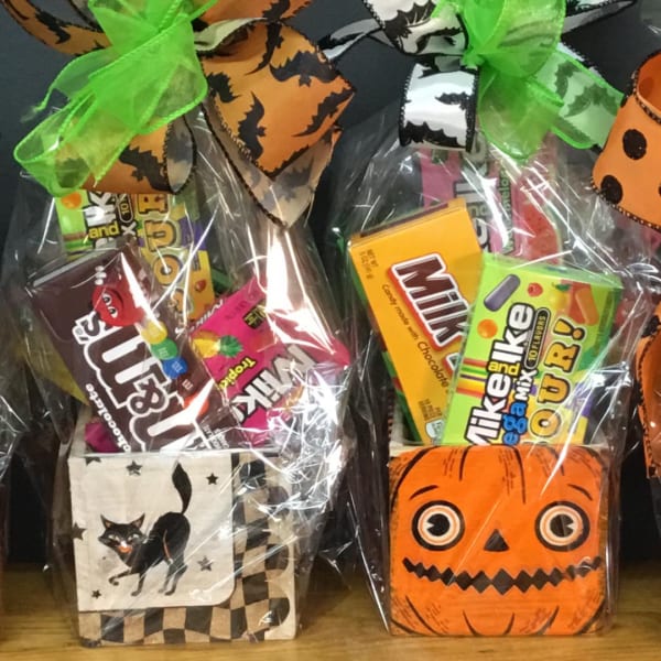 Halloween candy gift bags with ribbon bows and assorted chocolates