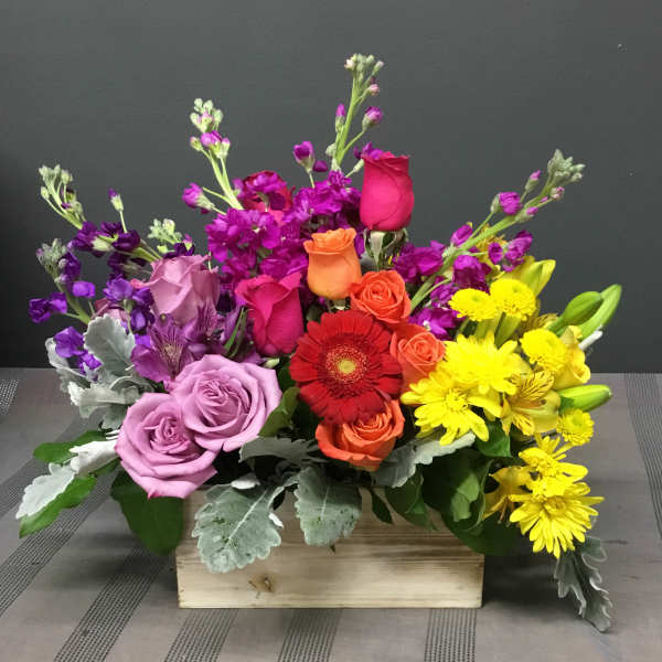 Colorful mixed flower arrangement in a wooden box