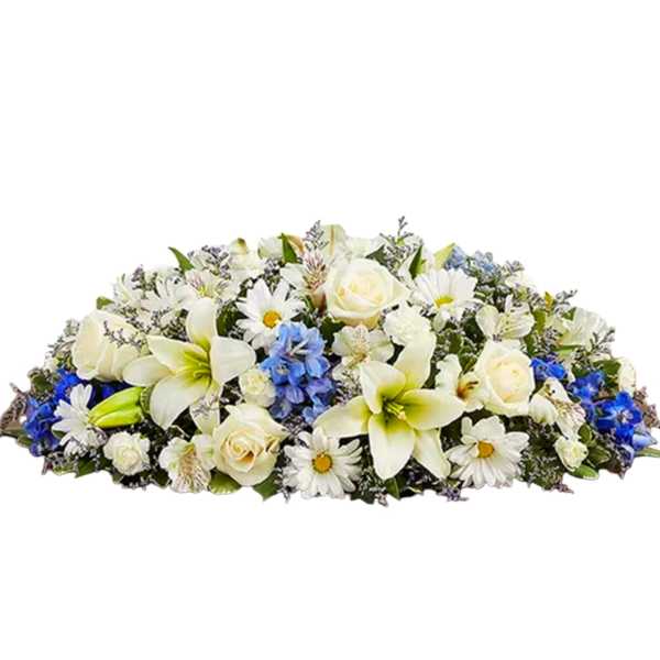 White and blue floral casket spray with lilies, roses, and daisies