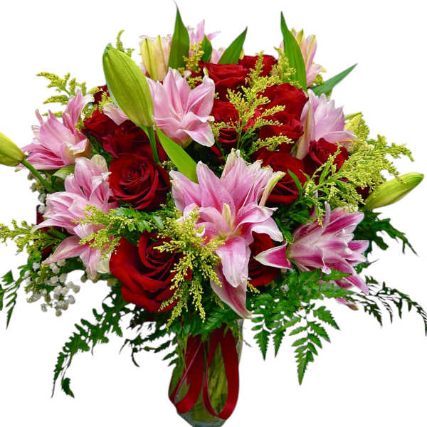Bouquet of red roses and pink lilies in a glass vase