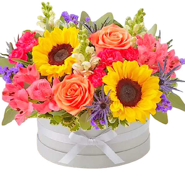 Bright mixed bouquet in a white round box with a ribbon