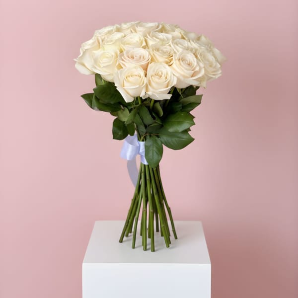 Bouquet of cream roses tied with a pale blue ribbon