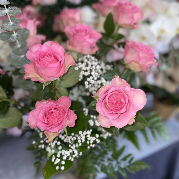 Pink roses with baby's breath and eucalyptus foliage