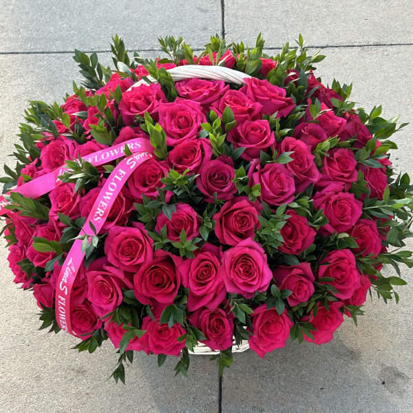 Large basket of hot pink roses with a pink ribbon