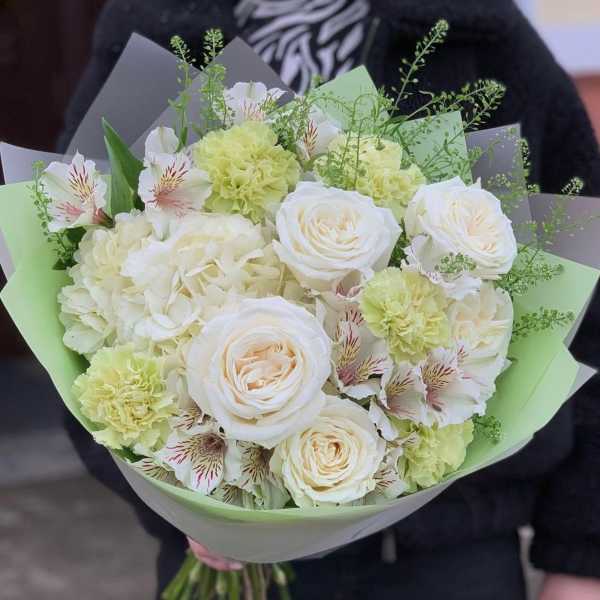 Bouquet of white roses, pale green carnations, and striped alstroemeria
