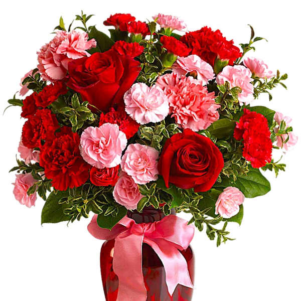 Red roses and pink carnations in a red vase with a pink ribbon