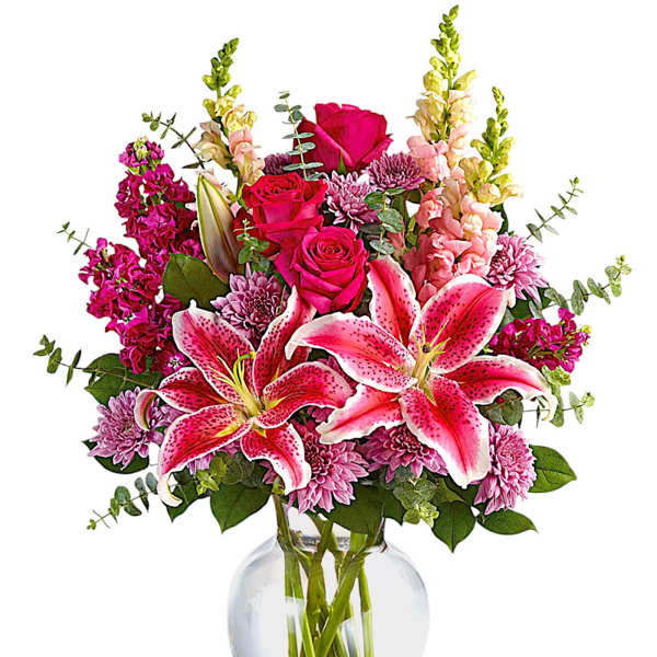 Pink lilies and roses in a clear glass vase