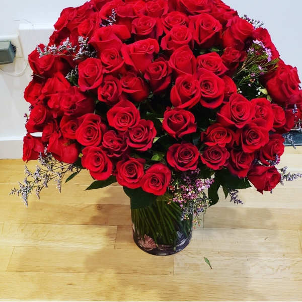Large bouquet of red roses in a glass vase