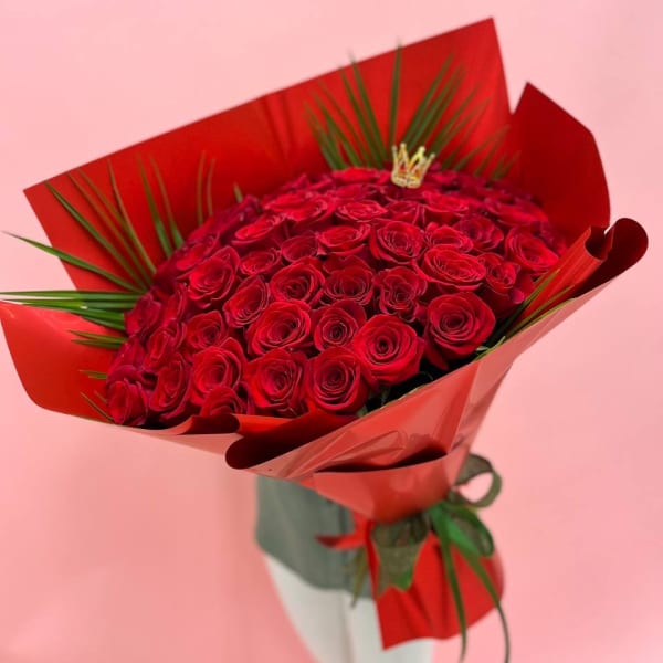 Large bouquet of red roses wrapped in red paper