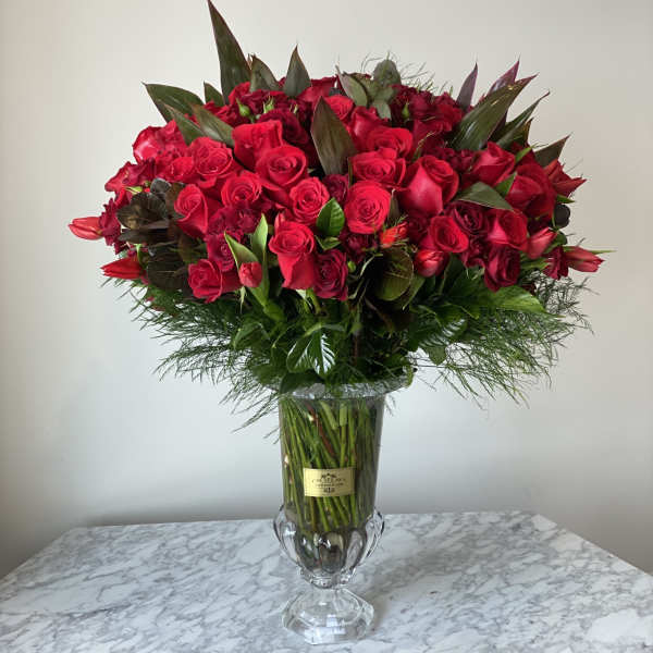 Large bouquet of red roses in a clear glass vase
