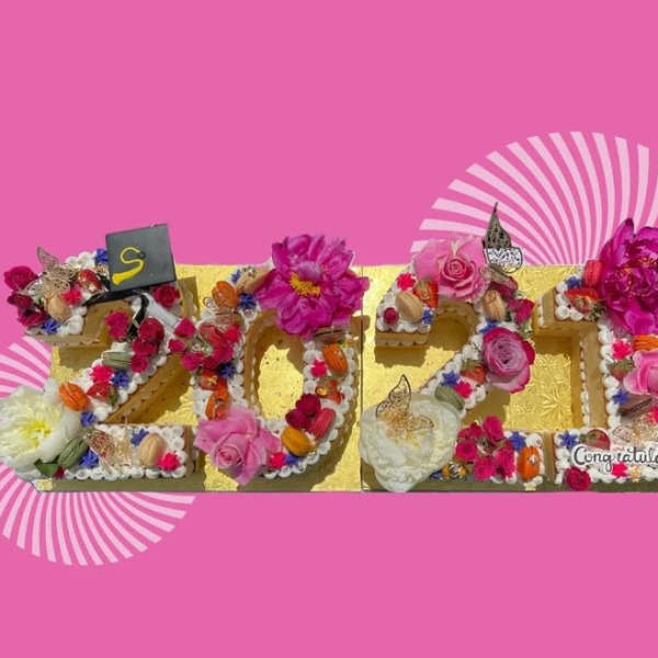 Decorative floral arrangement spelling 2024 with pink and white flowers
