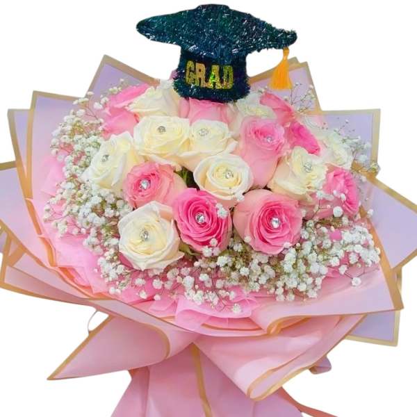 Pink and white rose bouquet with a graduation cap topper