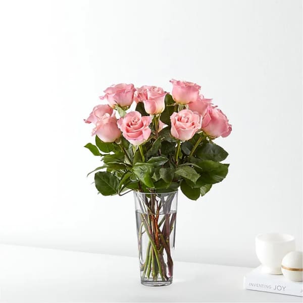 Pink roses arranged in a clear glass vase