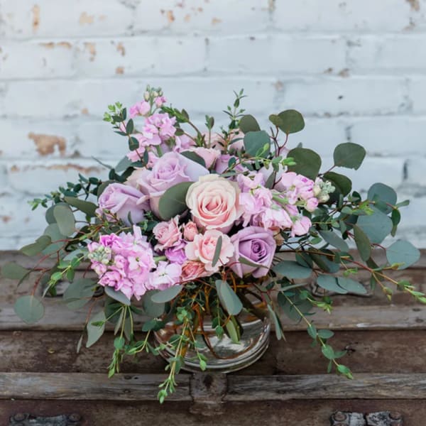 Pink and lavender rose bouquet in a clear glass vase