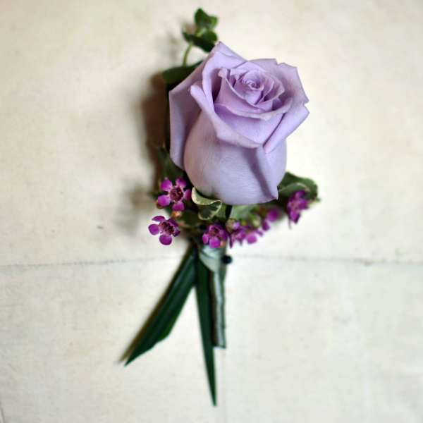 Lavender rose boutonniere with small purple accent flowers