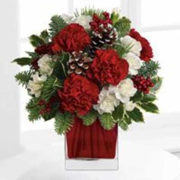 Red and white floral arrangement in a clear glass vase