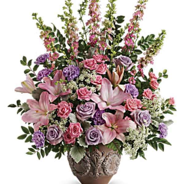 Pink and lavender floral arrangement in a decorative vase