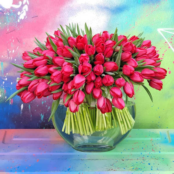 Pink tulips arranged in a clear glass vase